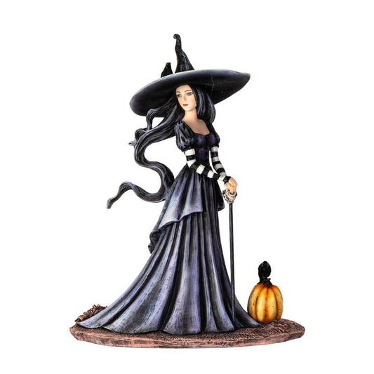 Statue of a witch with a pumpkin on a white background