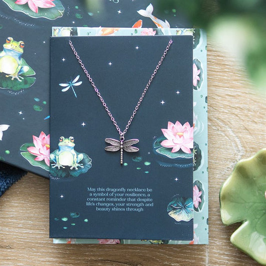 Silver-tone dragonfly necklace on tranquil pond-themed card