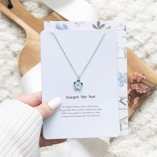 Forget-me-not flower necklace on greeting card with envelope