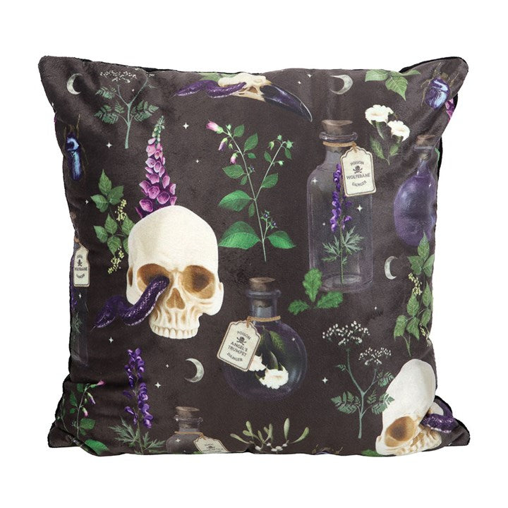 Black throw pillow with skulls, snakes, and poisonous plants