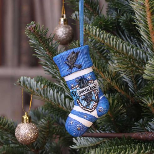 Blue decorative stocking ornament with 'Ravenclaw' text hanging on a Christmas tree.