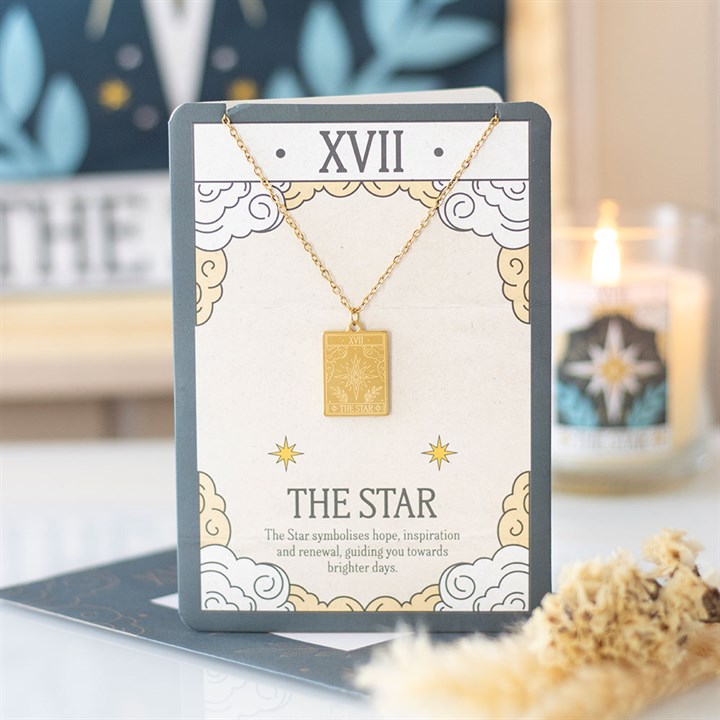Gold coloured tarot necklace with The Star pendant on greeting card