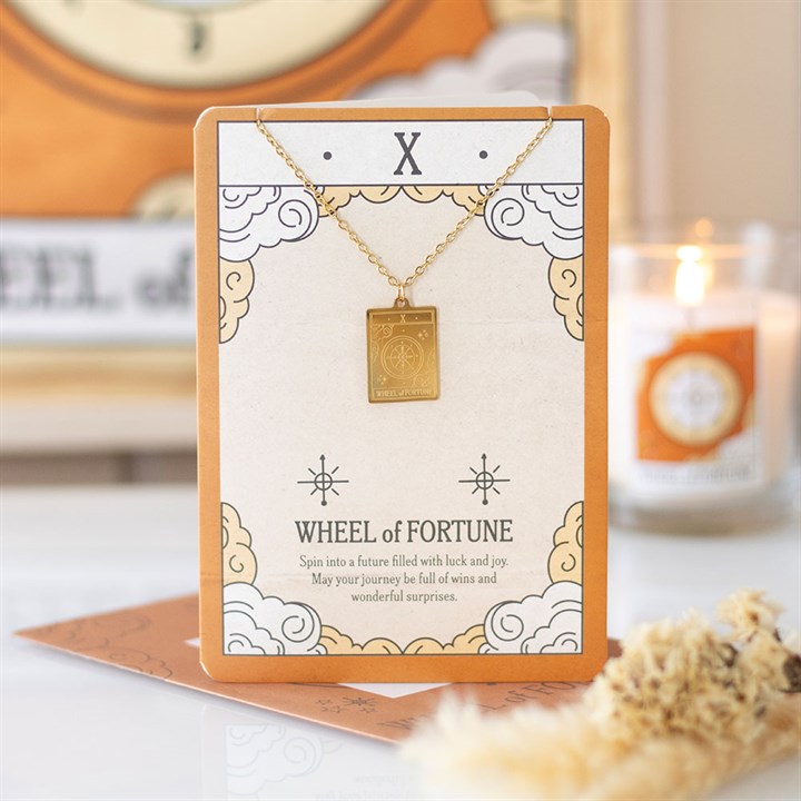Wheel of Fortune tarot necklace on card with gold pendant