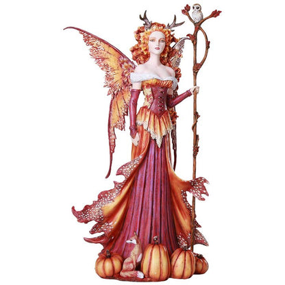 Fantasy fairy figurine with orange hair, wings, and a staff on a white background
