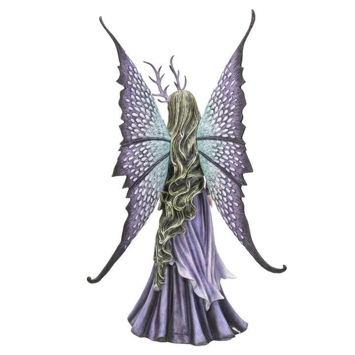 Fairy figurine with purple and green wings on a white background