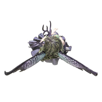 Fantasy creature figurine with large wings and detailed head on a white background