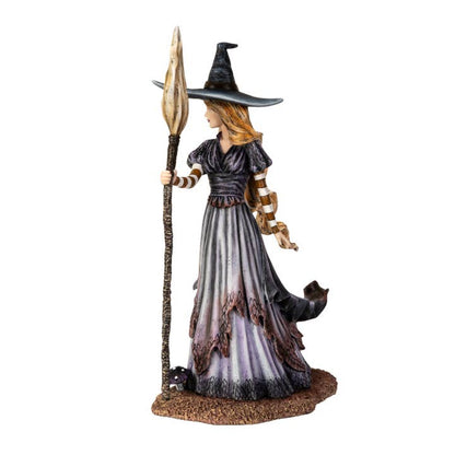 Statue of a witch with a broom and a cat on a white background