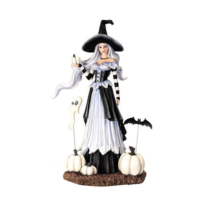 Halloween-themed figurine of a witch with pumpkins and a ghost on a white background