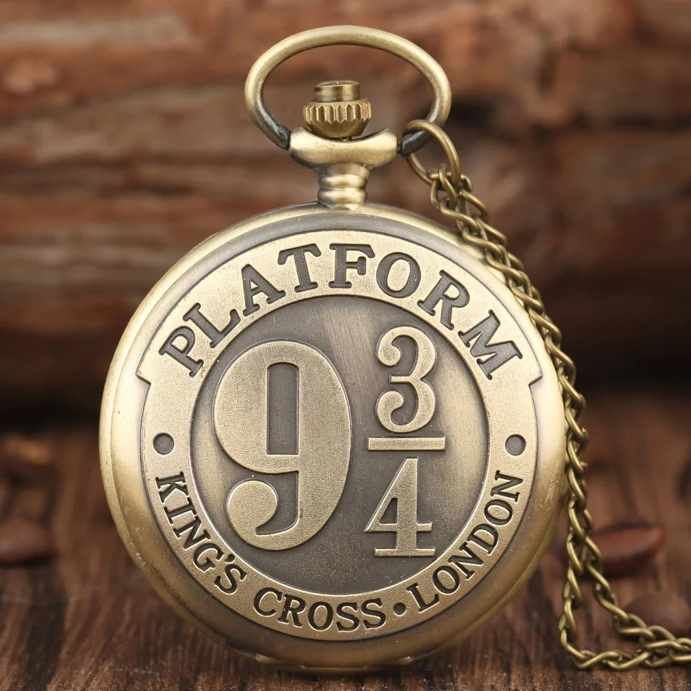 Bronze pocket watch with 'Platform 9 3/4' text on a wooden background