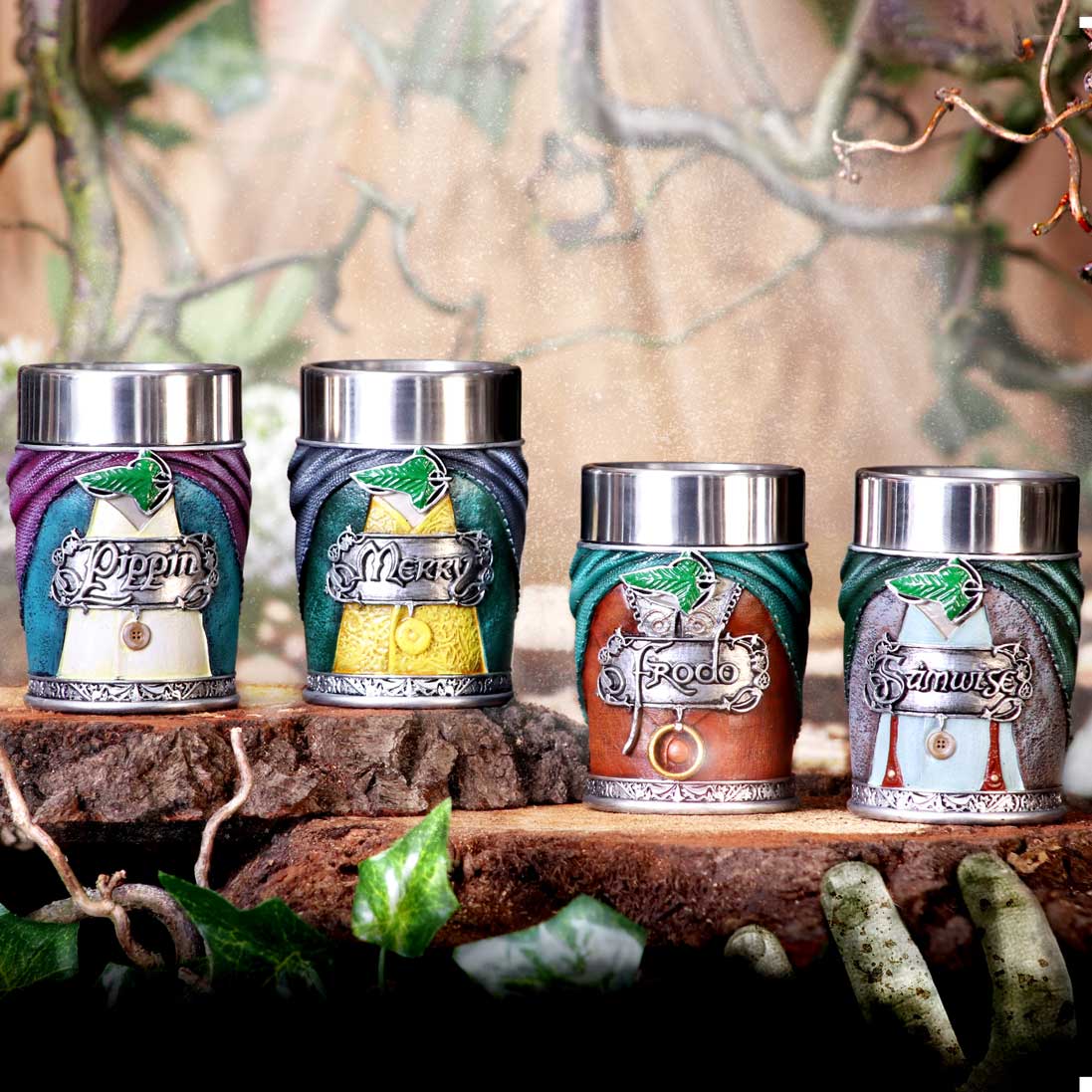 Set of 'The Lord of the Rings' themed shot glasses in a decorative box on a wooden surface with a natural background.