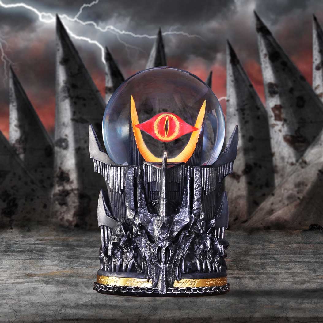 Decorative piece with a crystal ball featuring a red and yellow eye design, set against a dark, stormy background.