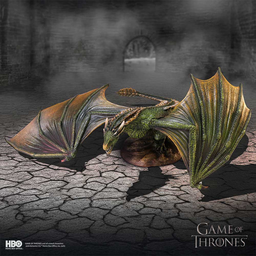 Model of a dragon from 'Game of Thrones' on a cracked stone floor with a dark background.