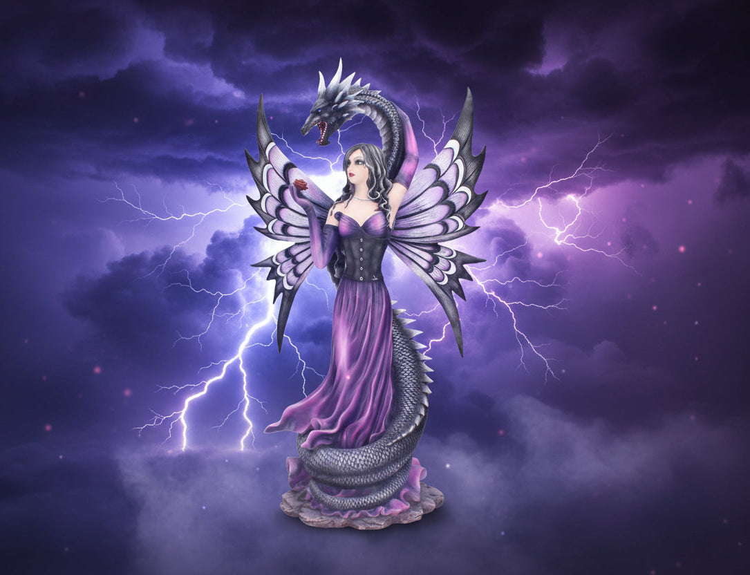 Statue of a fantasy figure with dragon wings and a purple dress on a white background
