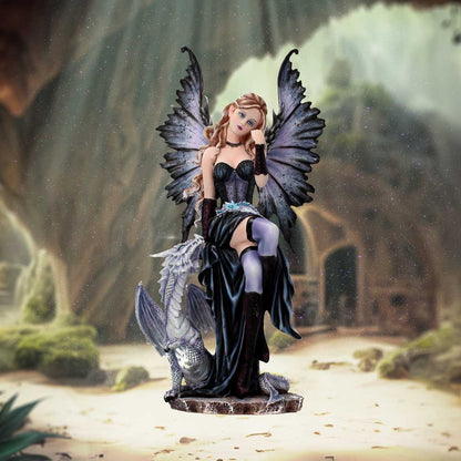 Statue of a fairy with wings and a dragon in a fantasy landscape