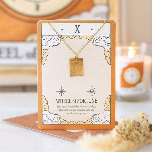 Wheel of Fortune tarot necklace on card with gold pendant